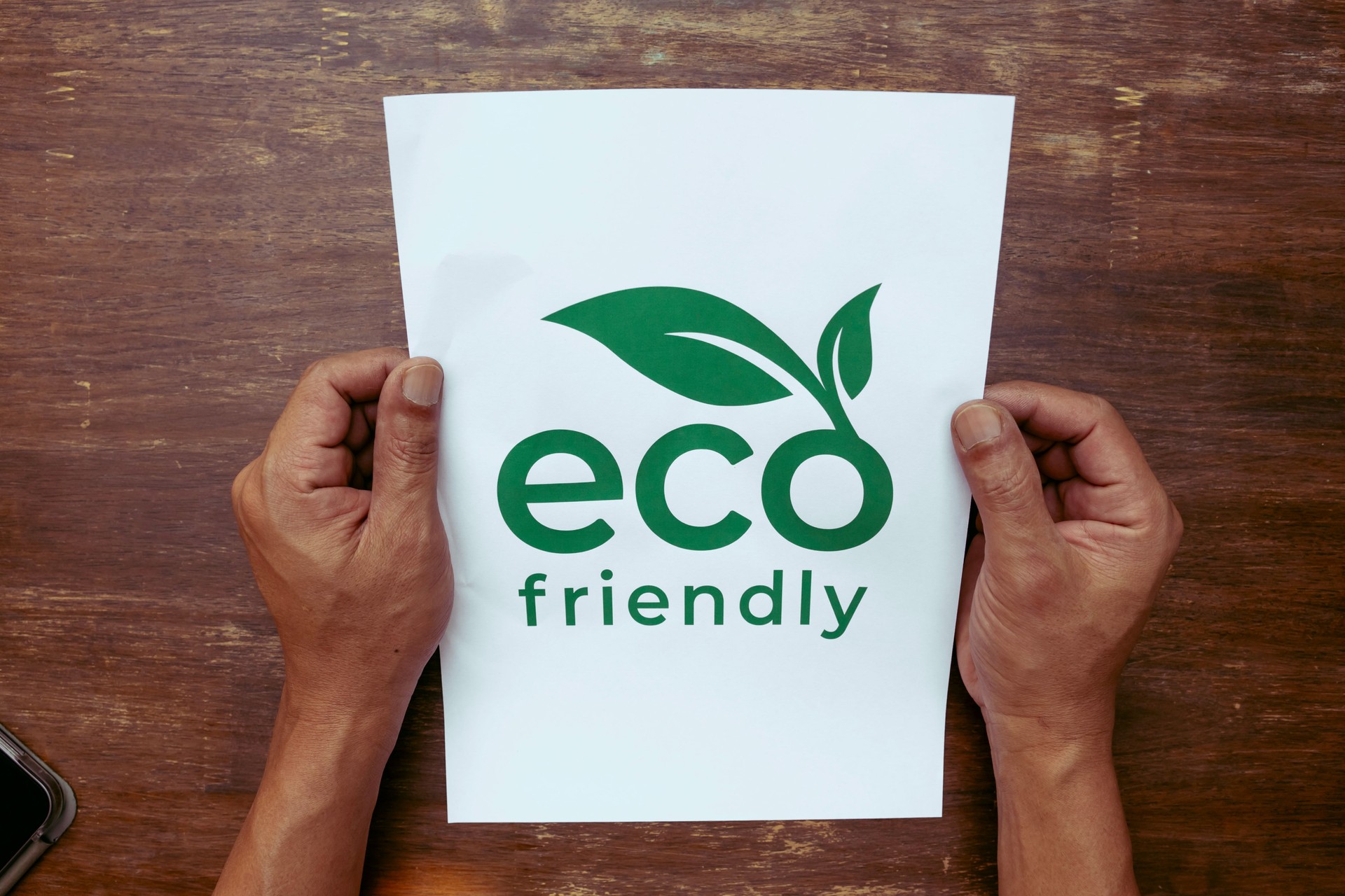 Male hand holds paper made from recycled materials. environmentally friendly